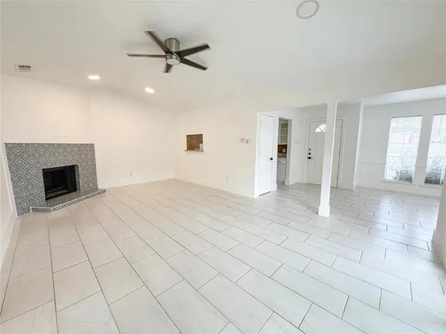 wooden floor in an empty room with a ceiling fan