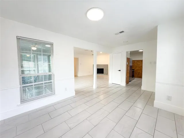 an empty room with windows and entrance