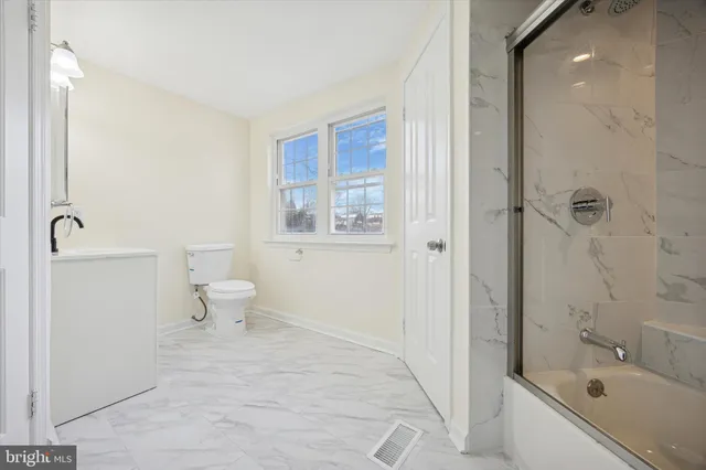 a bath room with a toilet and a bath tub
