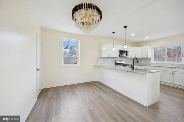 a view of kitchen with cabinets and wooden floor
