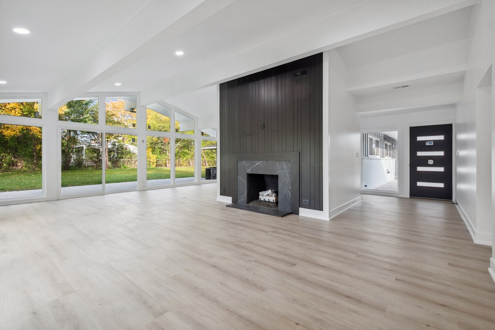 3131 Willow Road Northbrook, IL 60062 - Photo 3 of 23 an empty room with wooden floor fireplace and windows