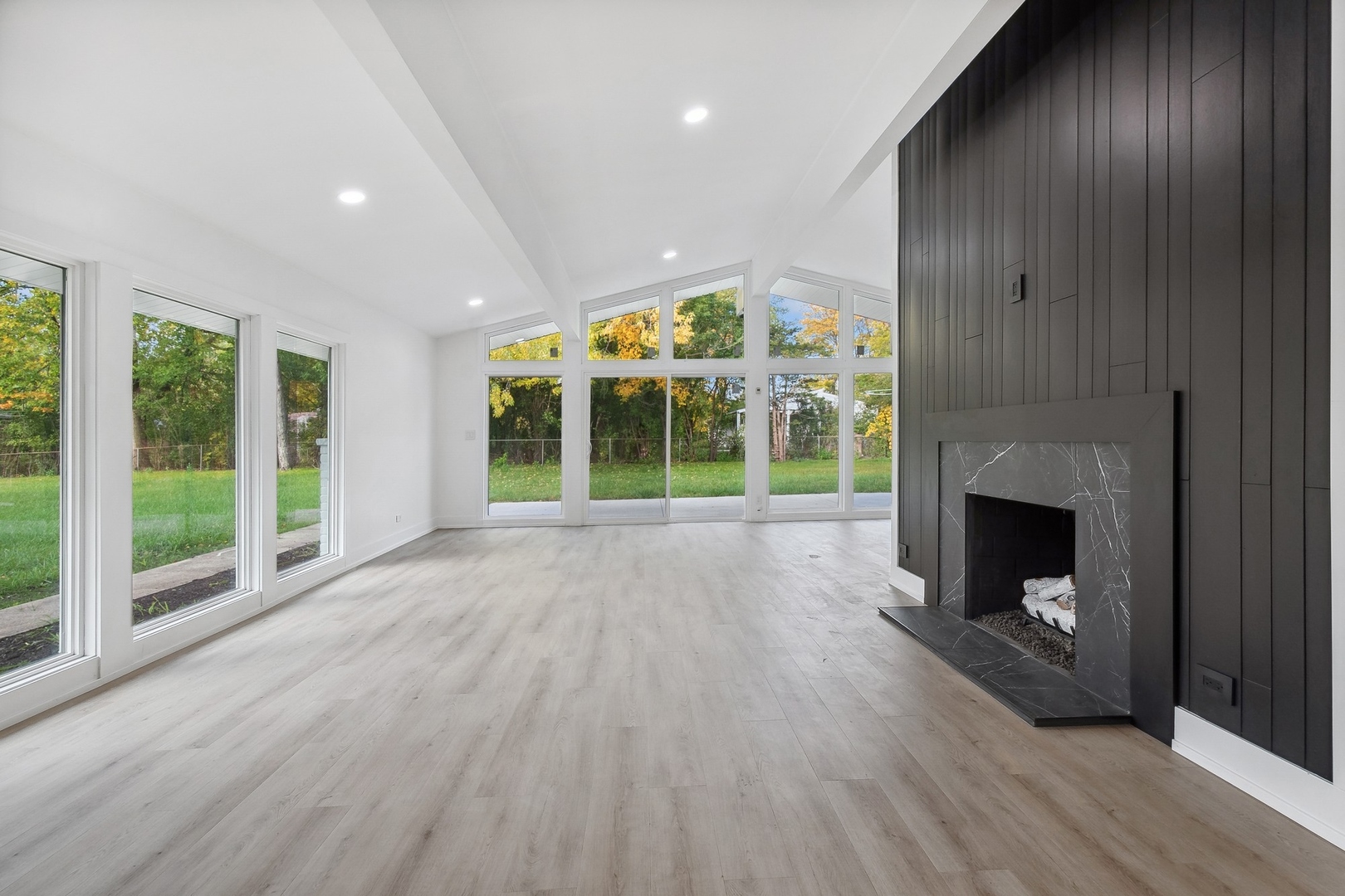 3131 Willow Road Northbrook, IL 60062 - Photo 5 of 23 a view of an empty room with wooden floor fireplace and a window