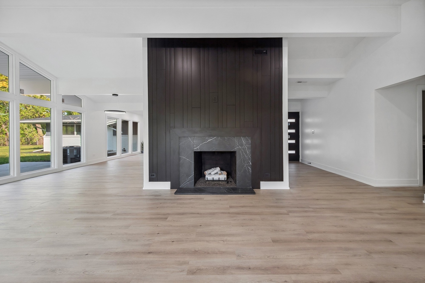 3131 Willow Road Northbrook, IL 60062 - Photo 6 of 23 a view of an empty room with wooden floor fireplace and a window