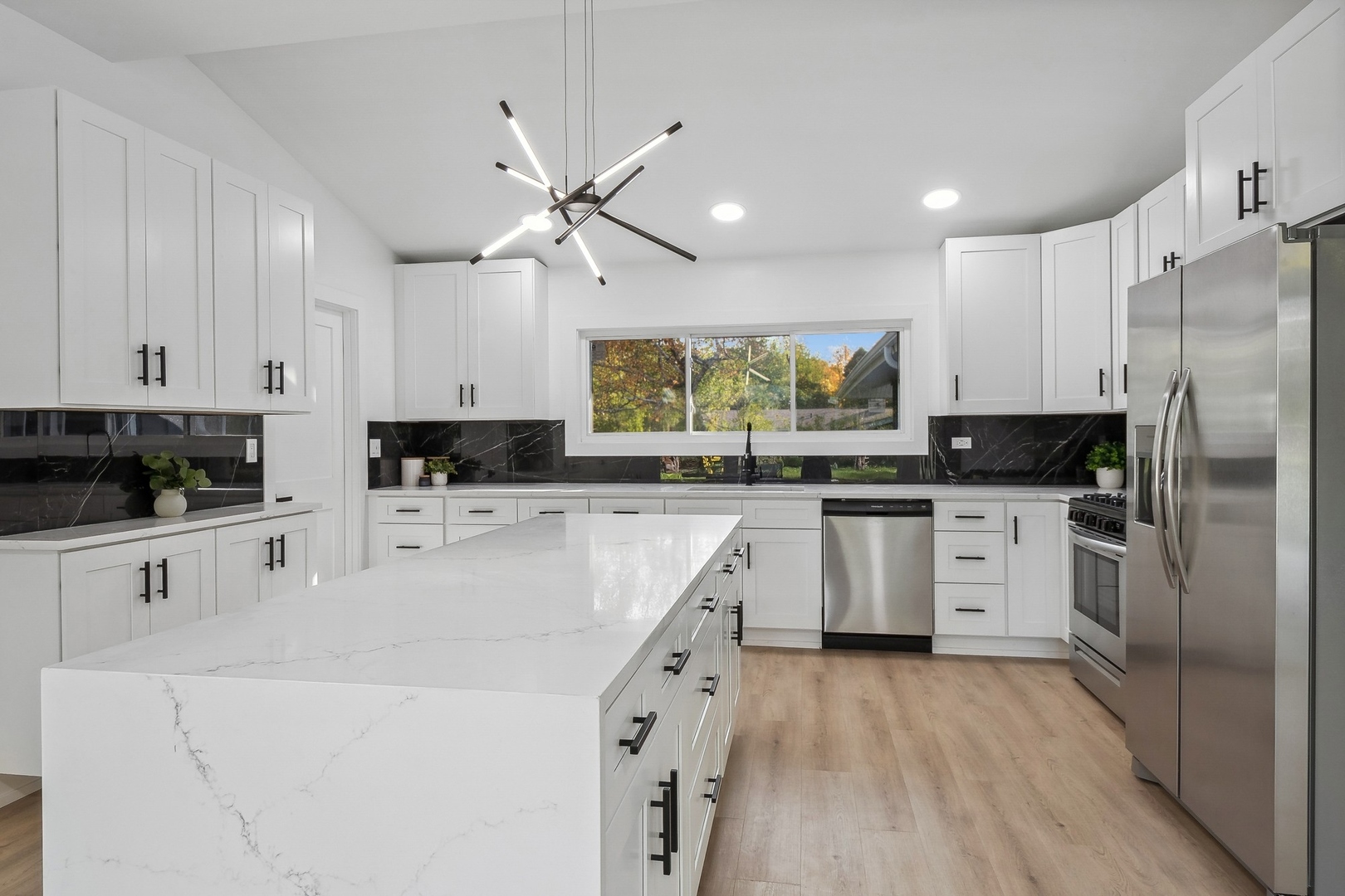 3131 Willow Road Northbrook, IL 60062 - Photo 10 of 23 a kitchen with white cabinets and stainless steel appliances
