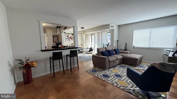a living room with furniture and wooden floor