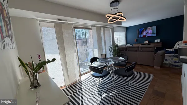 a living room with furniture a rug and a window