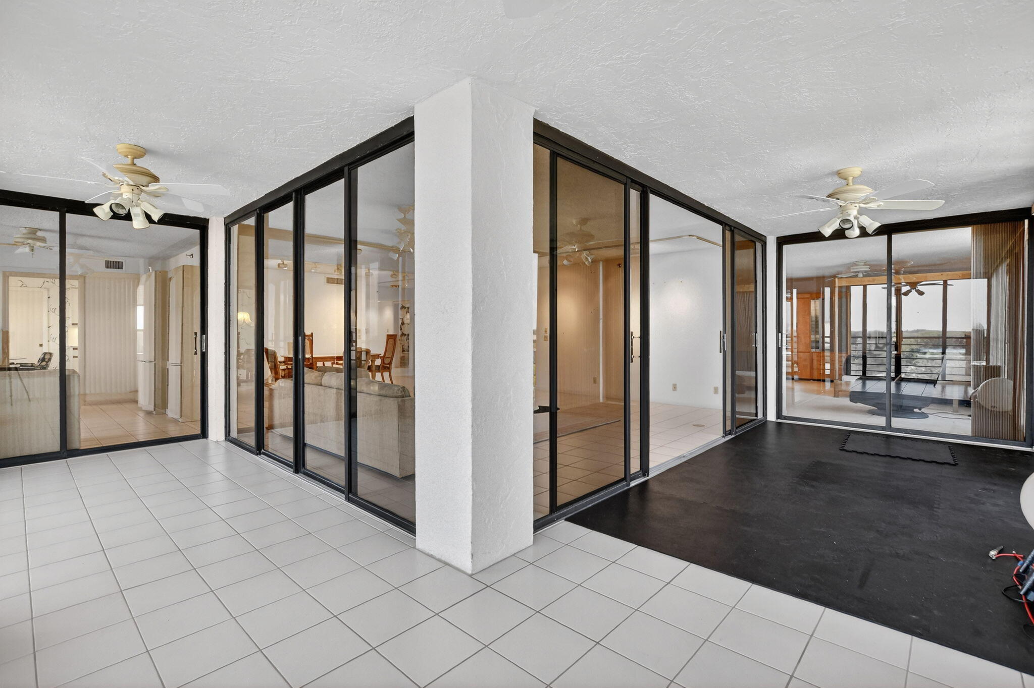 7564 Regency Lake Drive, Unit 701 Boca Raton, FL 33433 - Photo 15 of 47 an empty room with floor to ceiling windows and painted walls