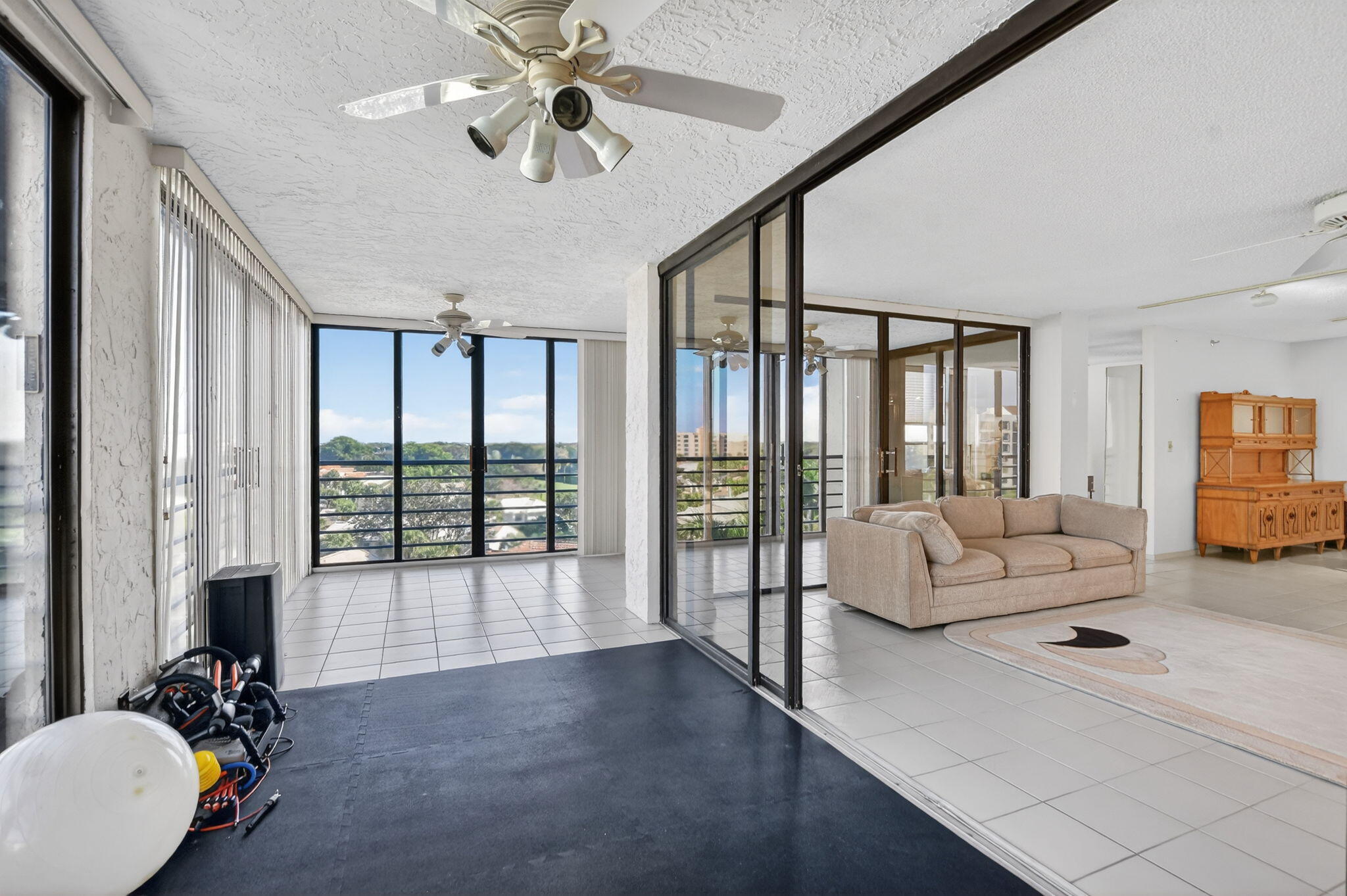 7564 Regency Lake Drive, Unit 701 Boca Raton, FL 33433 - Photo 16 of 47 a living room with furniture and a large window