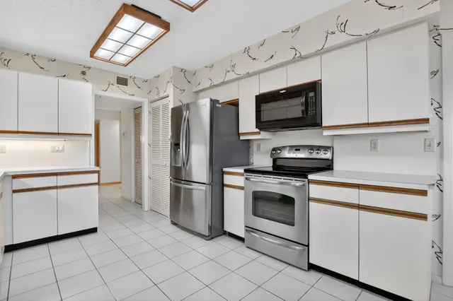 a kitchen with stainless steel appliances a sink and cabinets