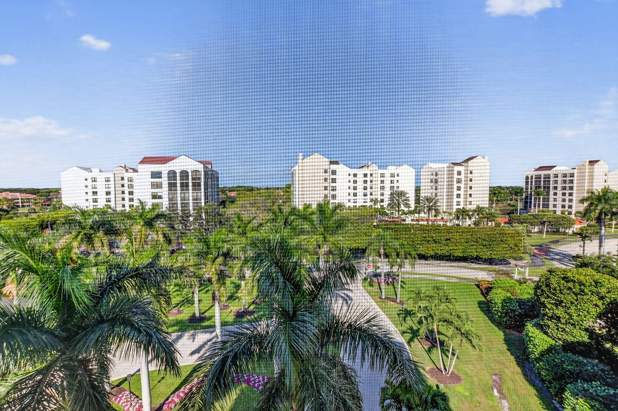 7564 Regency Lake Drive, Unit 701 Boca Raton, FL 33433 - Photo 2 of 47 a view of a city and tall buildings
