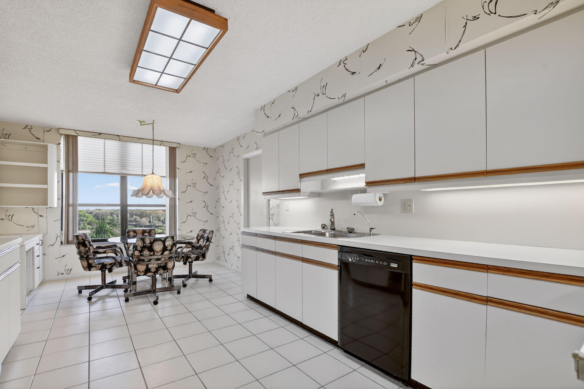 7564 Regency Lake Drive, Unit 701 Boca Raton, FL 33433 - Photo 21 of 47 a kitchen with stainless steel appliances a sink and cabinets