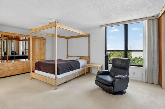 a bedroom with a bed couch and a window