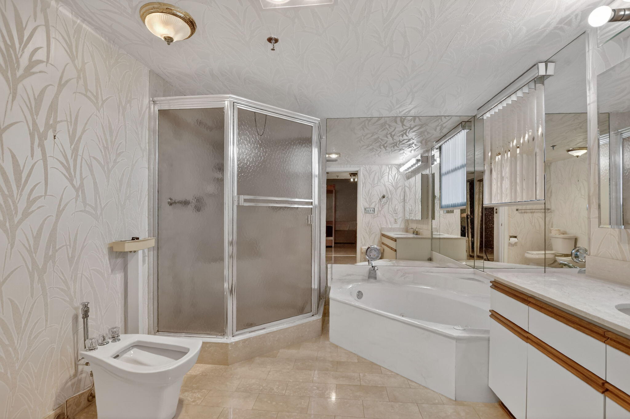 7564 Regency Lake Drive, Unit 701 Boca Raton, FL 33433 - Photo 29 of 47 a bathroom with a tub sink mirror and toilet