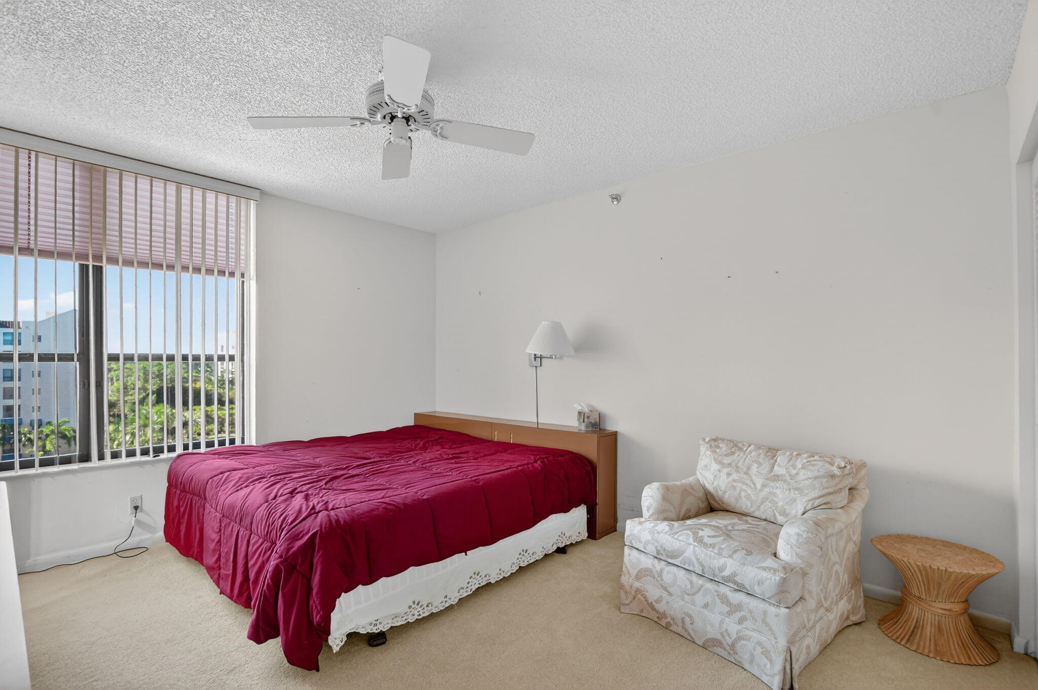 7564 Regency Lake Drive, Unit 701 Boca Raton, FL 33433 - Photo 33 of 47 a spacious bedroom with a bed and a couch