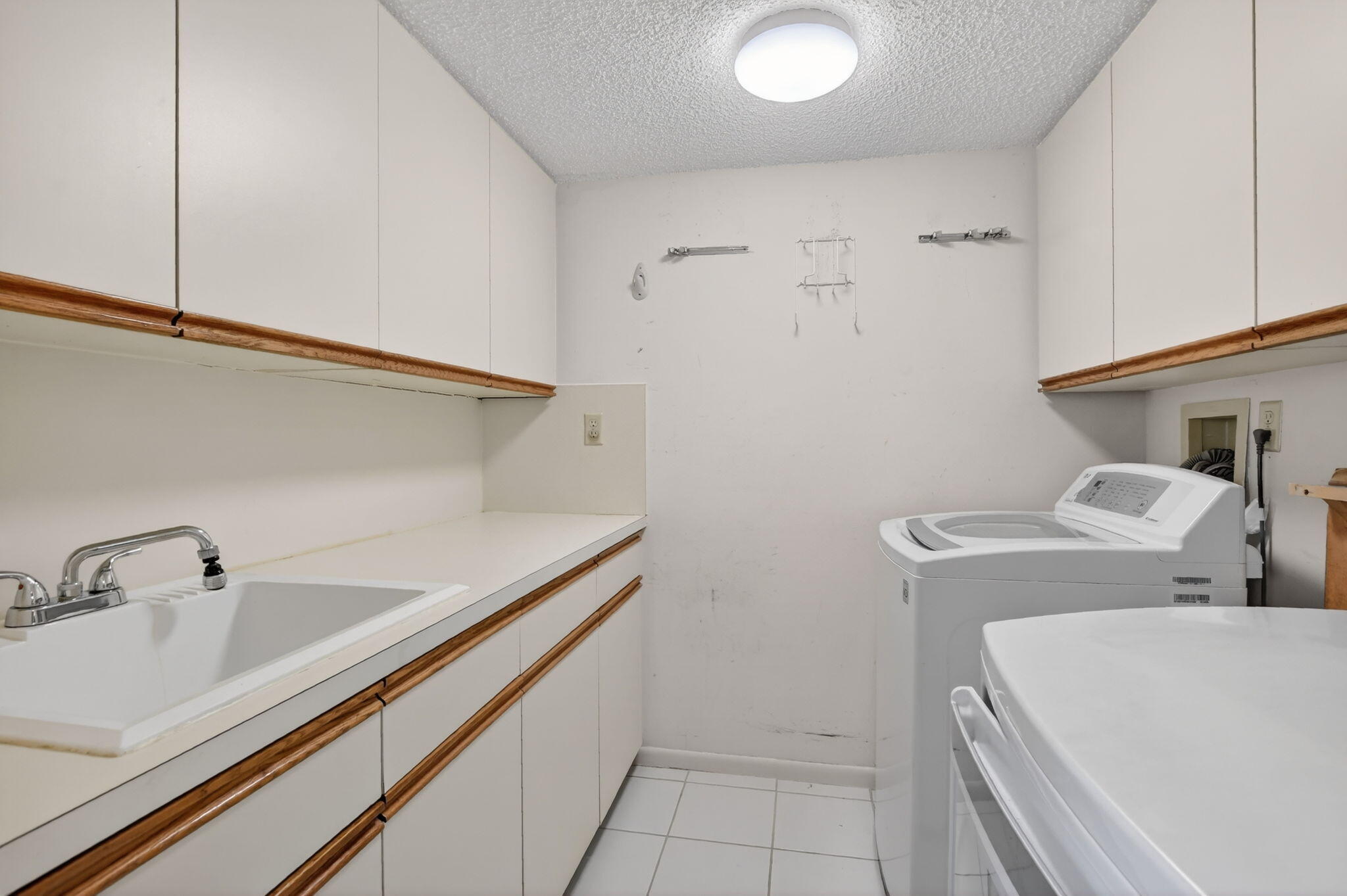 7564 Regency Lake Drive, Unit 701 Boca Raton, FL 33433 - Photo 42 of 47 a utility room with dryer and washer