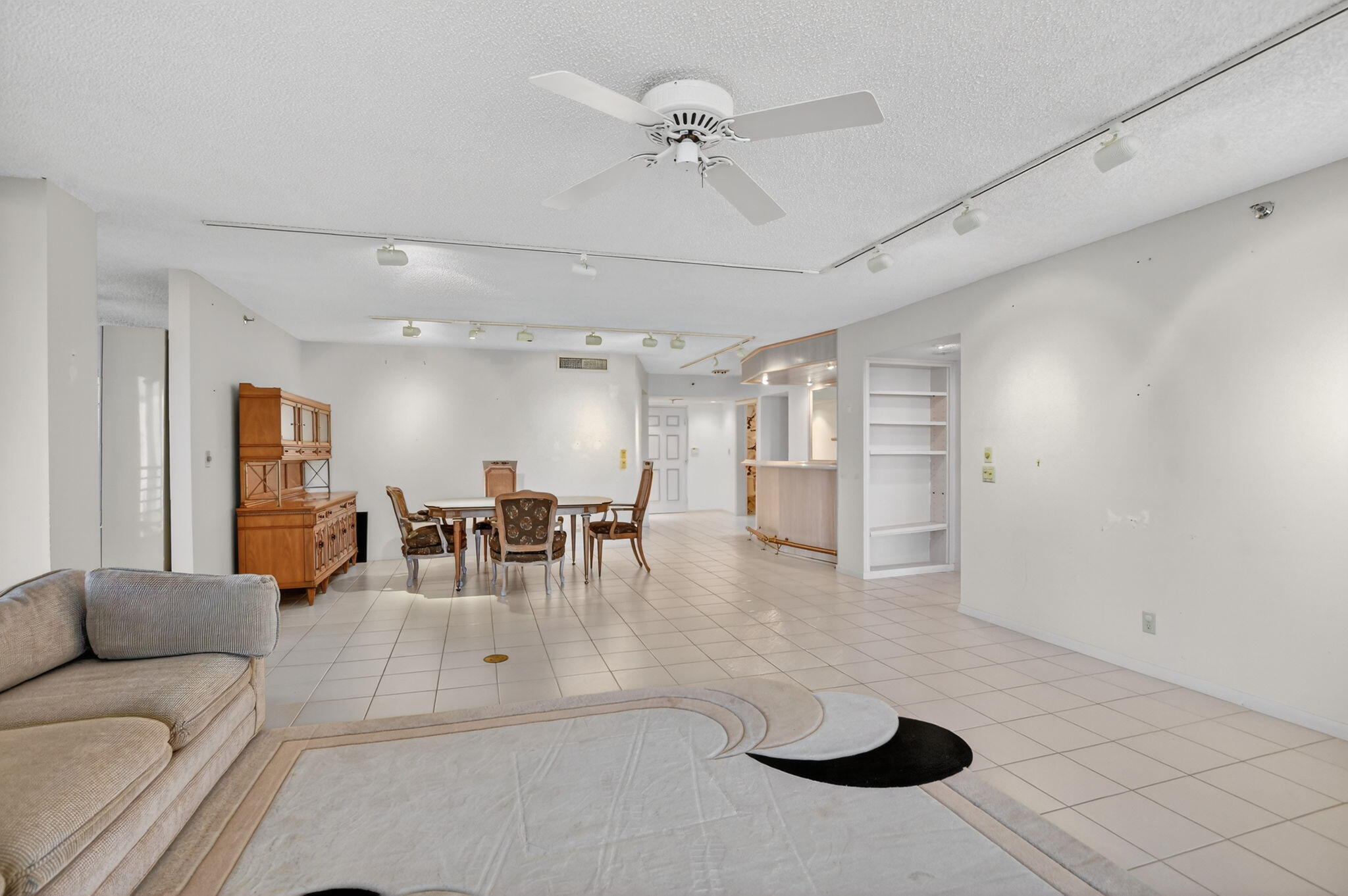 7564 Regency Lake Drive, Unit 701 Boca Raton, FL 33433 - Photo 7 of 47 a living room with furniture and a chandelier