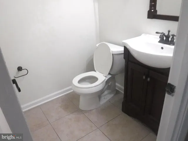a white toilet sitting next to a white sink