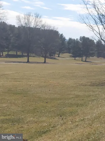 a view of a lake with trees in the background