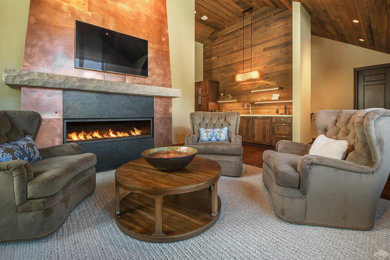 1183 Cabin Circle Vail, CO 81657 - Photo 15 of 19 a living room with furniture a flat screen tv and a fireplace