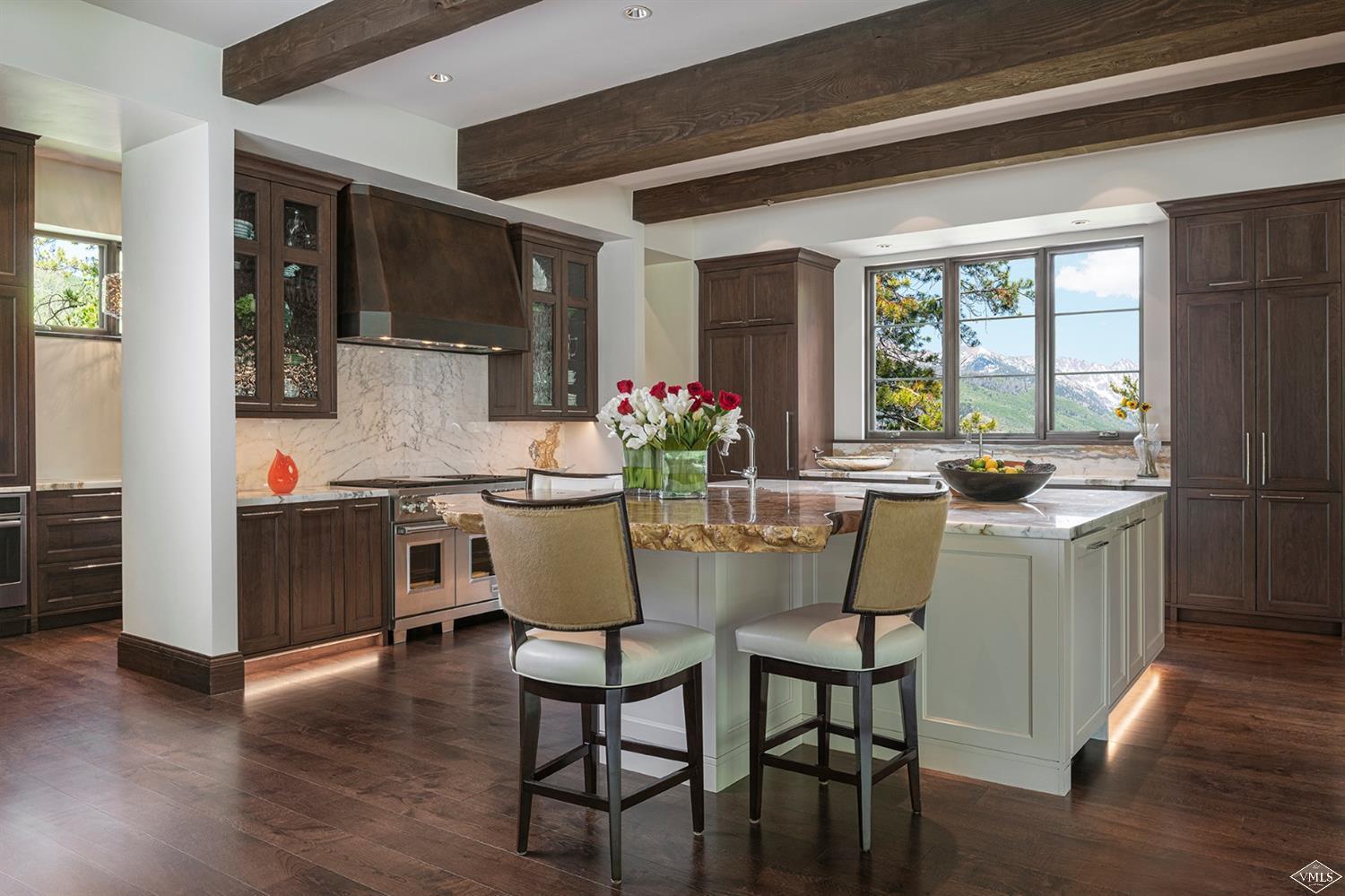 1183 Cabin Circle Vail, CO 81657 - Photo 2 of 19 a kitchen with a dining table chairs and refrigerator