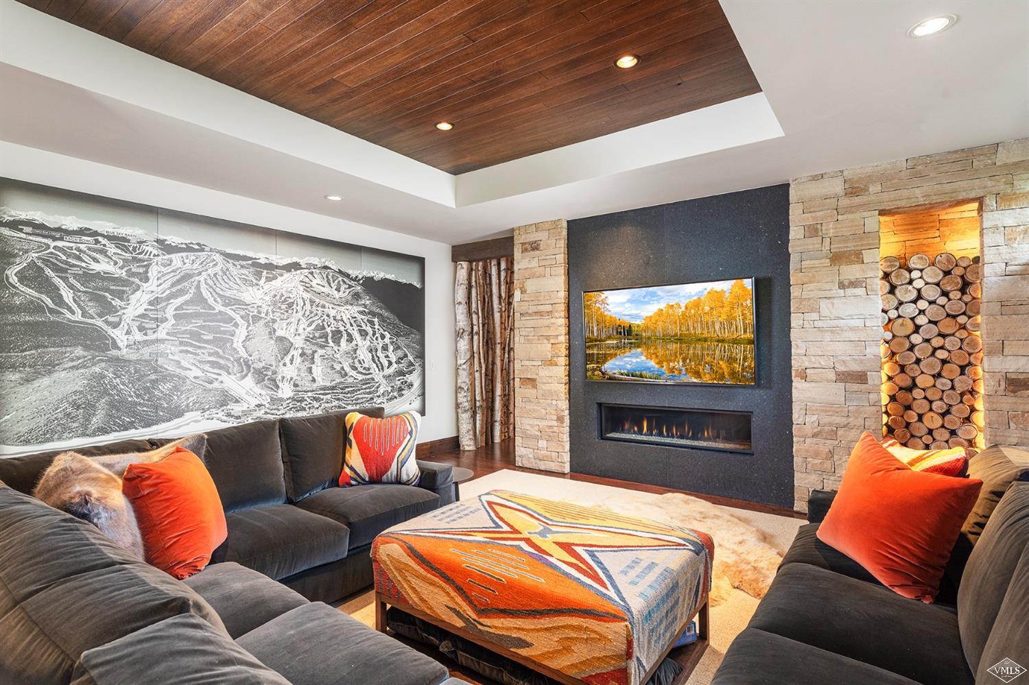 1183 Cabin Circle Vail, CO 81657 - Photo 6 of 19 a living room with a couch and a flat screen tv