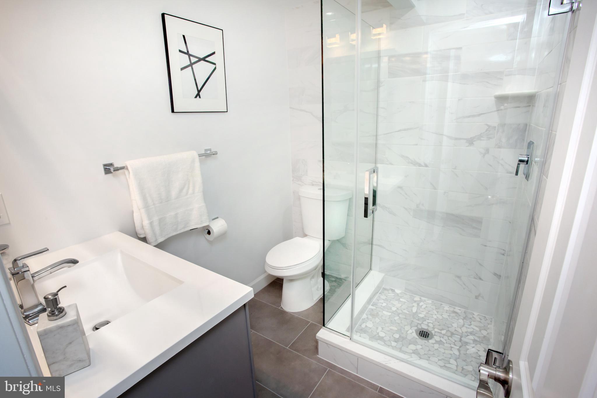 1364 W Street Northeast Washington, DC 20018 - Photo 34 of 80 Front bath has a glass shower, stone basin...;