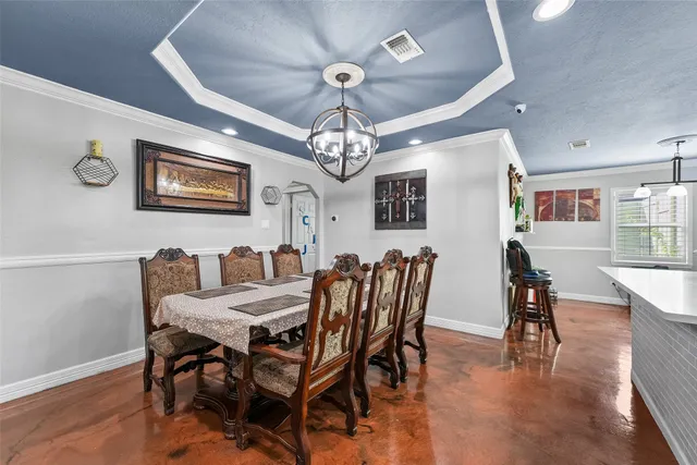 a view of a dining room with furniture and chandelier