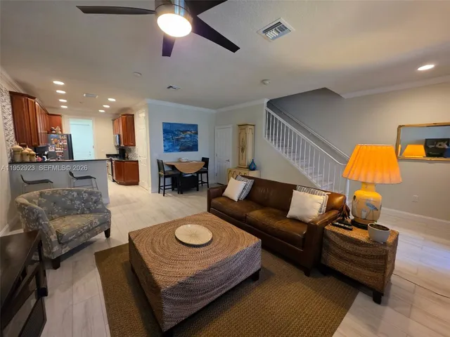 a living room with furniture and a lamp