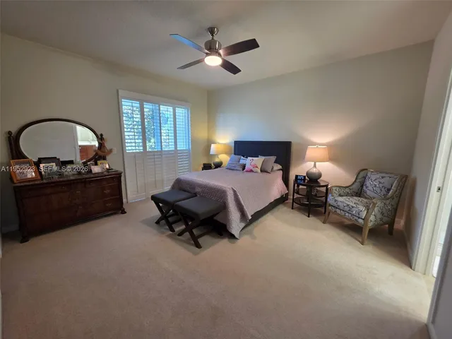 a living room with furniture and a ceiling fan