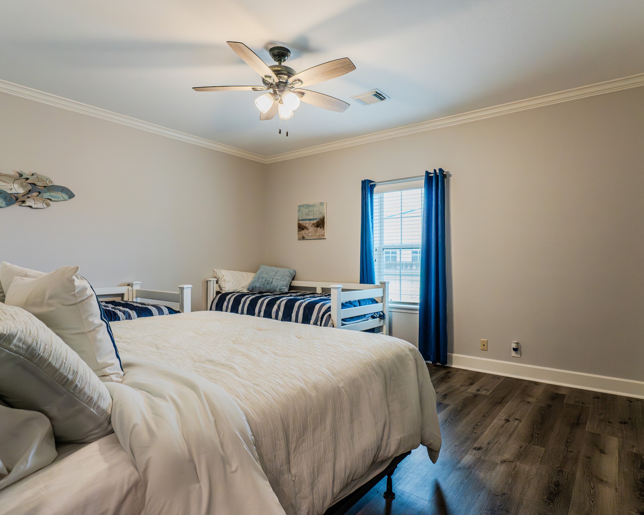 837 Wightman Street Matagorda, TX 77457 - Photo 28 of 45 a bedroom with a large bed and a chandelier