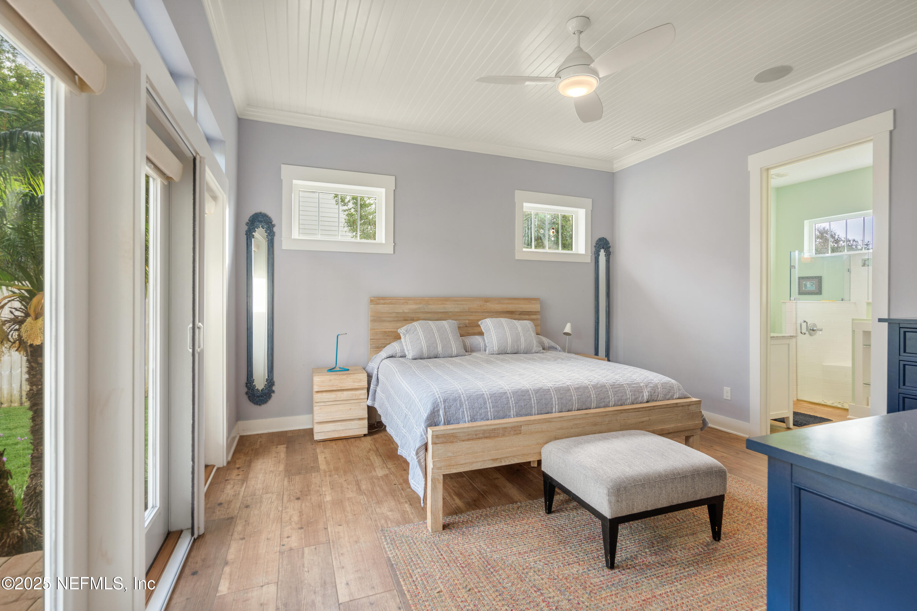 211 10th Street St. Augustine, FL 32080 - Photo 15 of 47 a bedroom with a bed and a chandelier