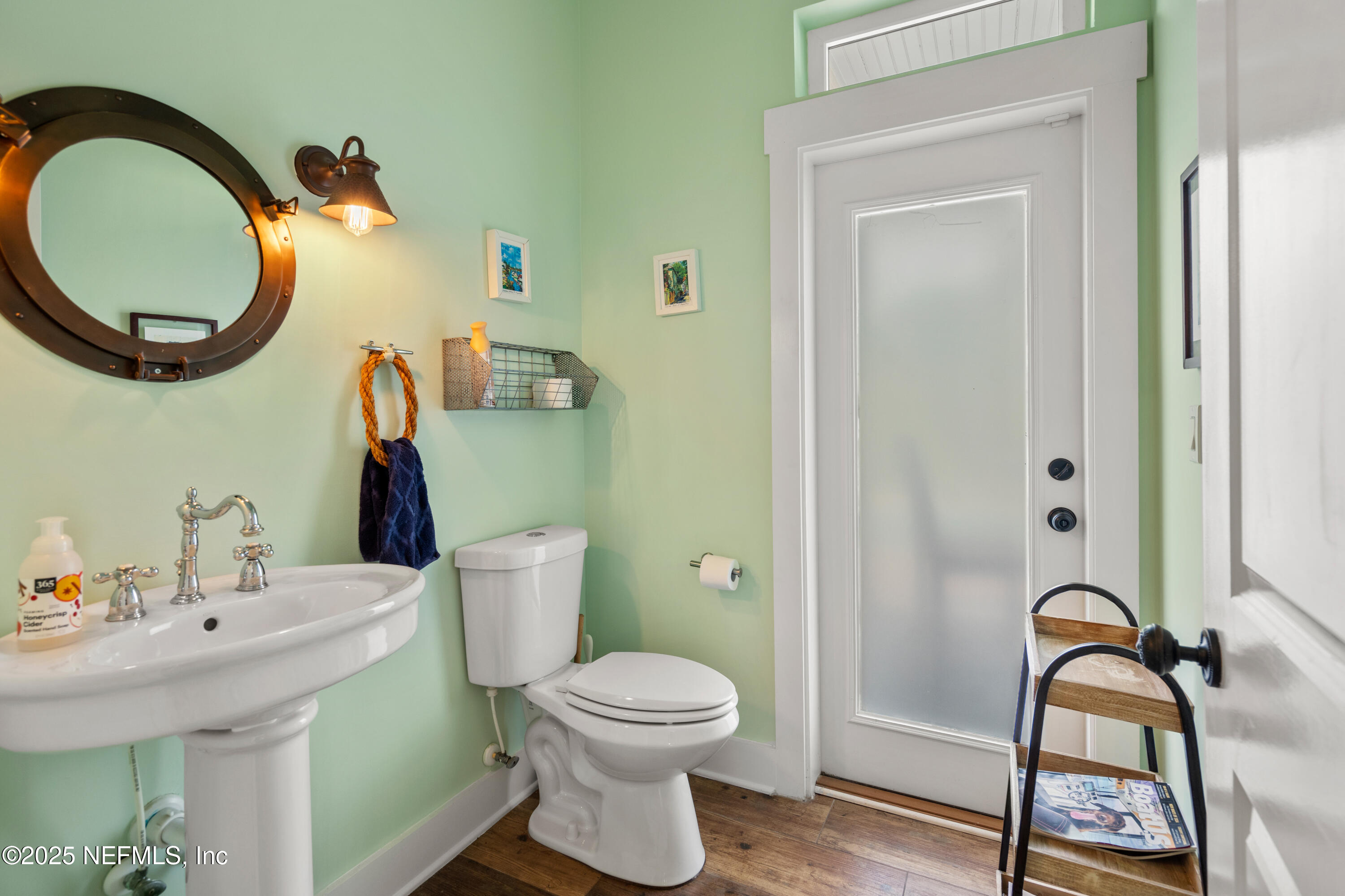 211 10th Street St. Augustine, FL 32080 - Photo 18 of 47 a bathroom with a sink and a mirror
