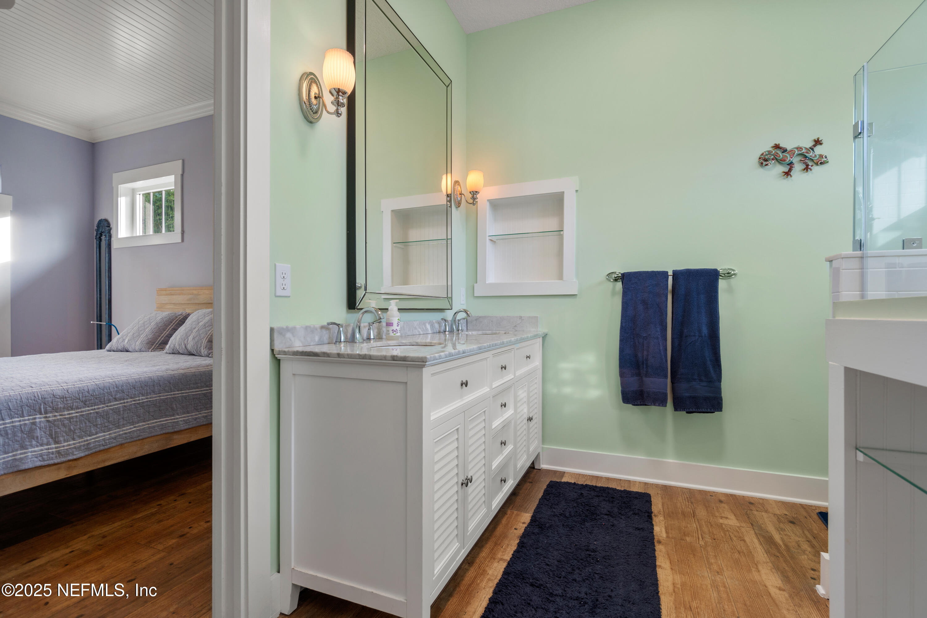 211 10th Street St. Augustine, FL 32080 - Photo 19 of 47 a spacious bathroom with a double vanity sink and a mirror