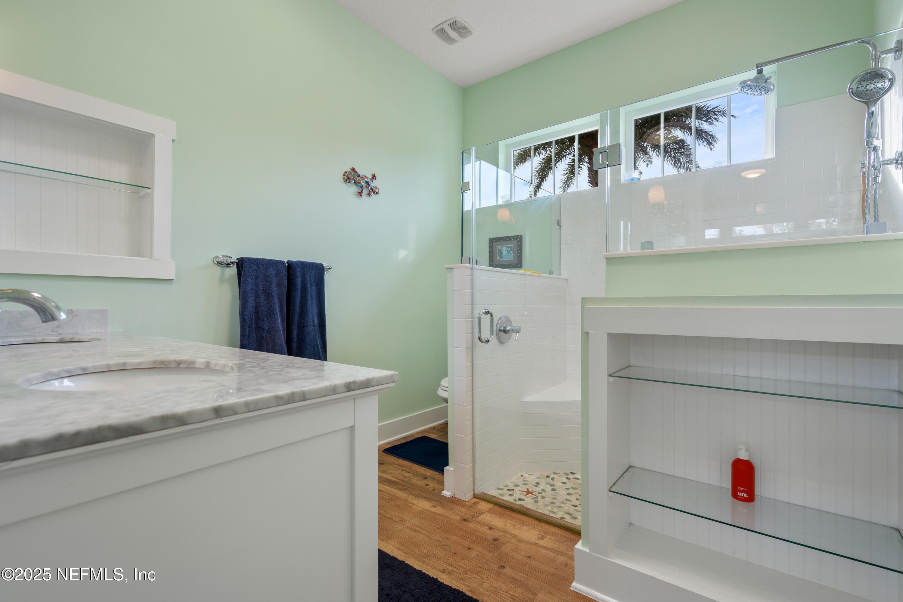 211 10th Street St. Augustine, FL 32080 - Photo 20 of 47 a bathroom with a sink and a mirror