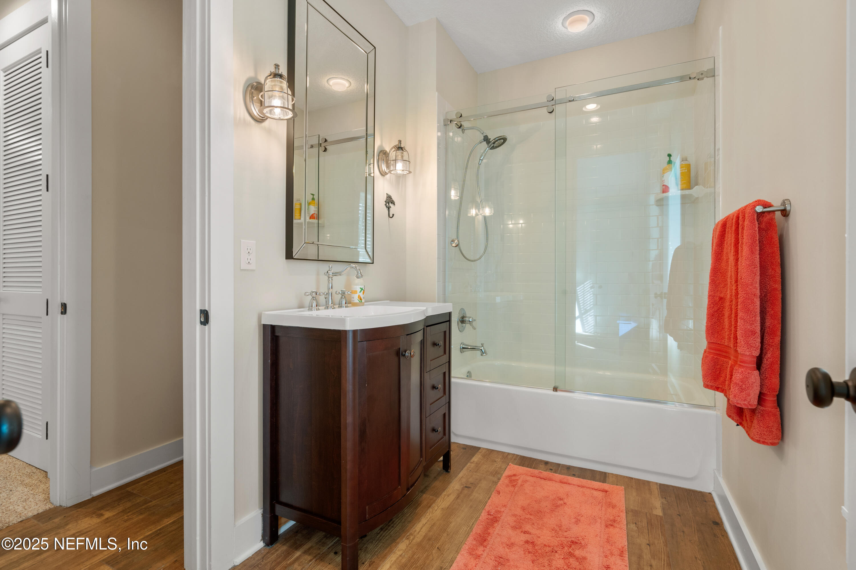 211 10th Street St. Augustine, FL 32080 - Photo 23 of 47 a bathroom with a bath tub a sink and a large mirror