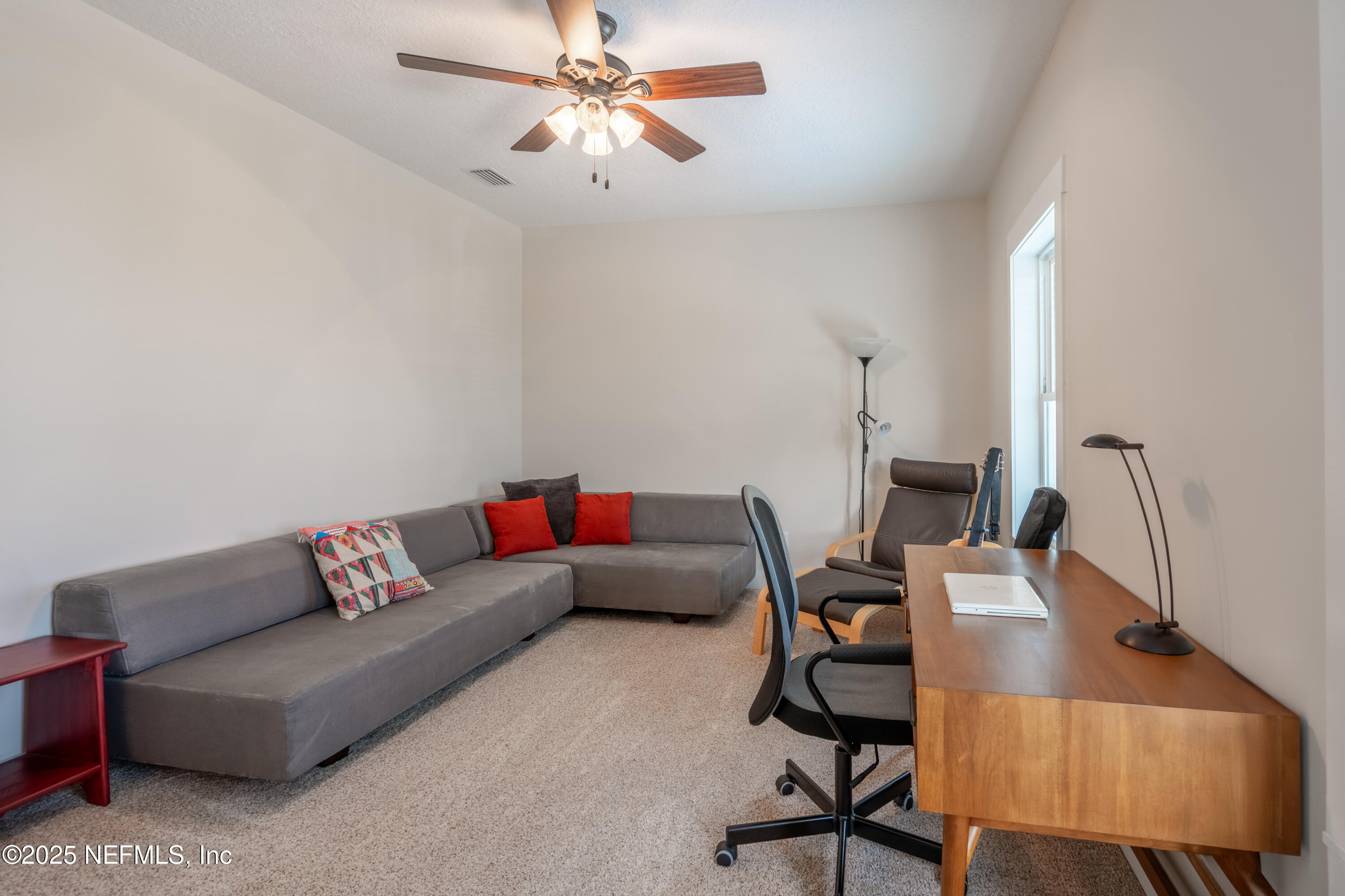 211 10th Street St. Augustine, FL 32080 - Photo 26 of 47 a living room with furniture and a chandelier
