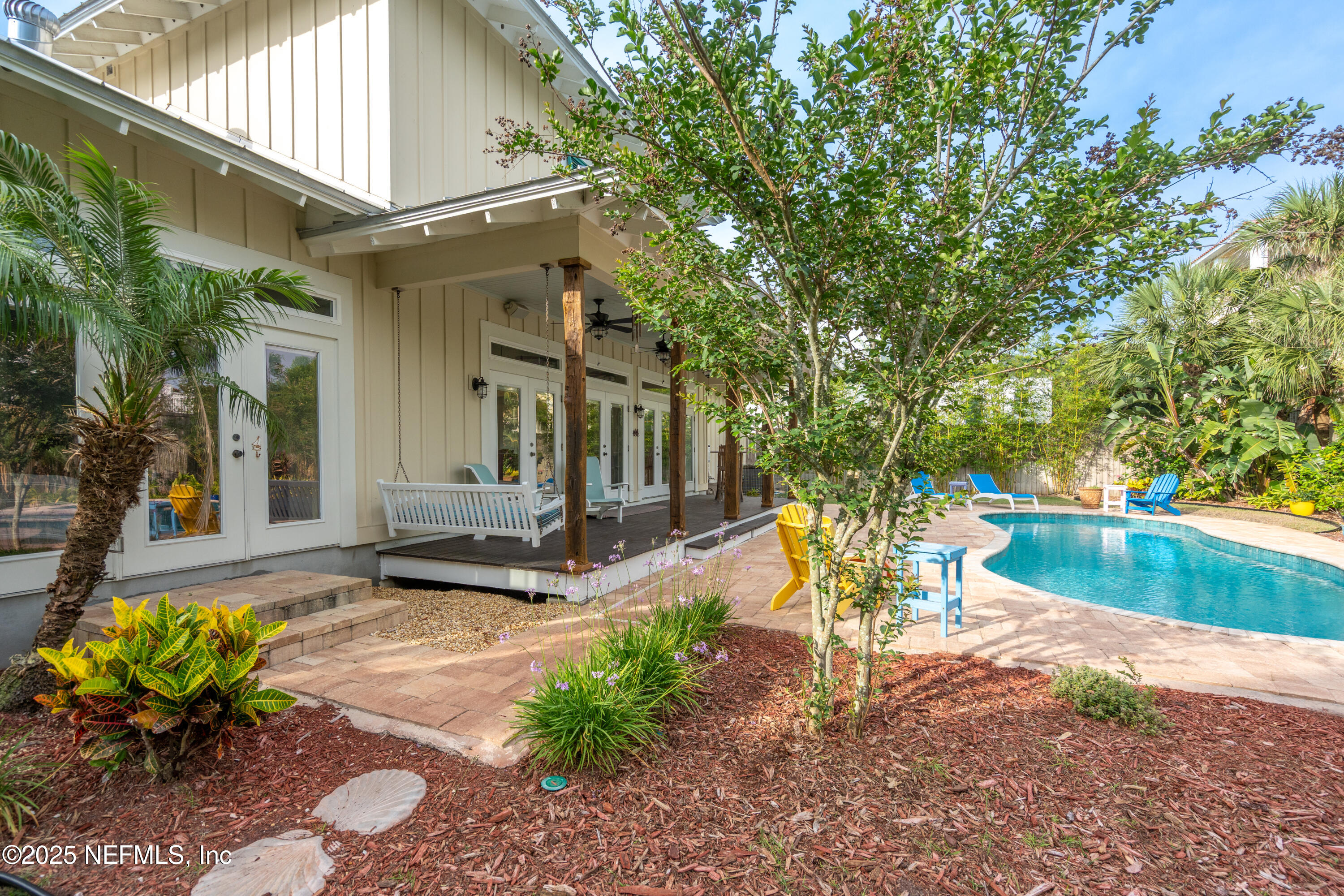 211 10th Street St. Augustine, FL 32080 - Photo 30 of 47 a view of a chair and table in the backyard