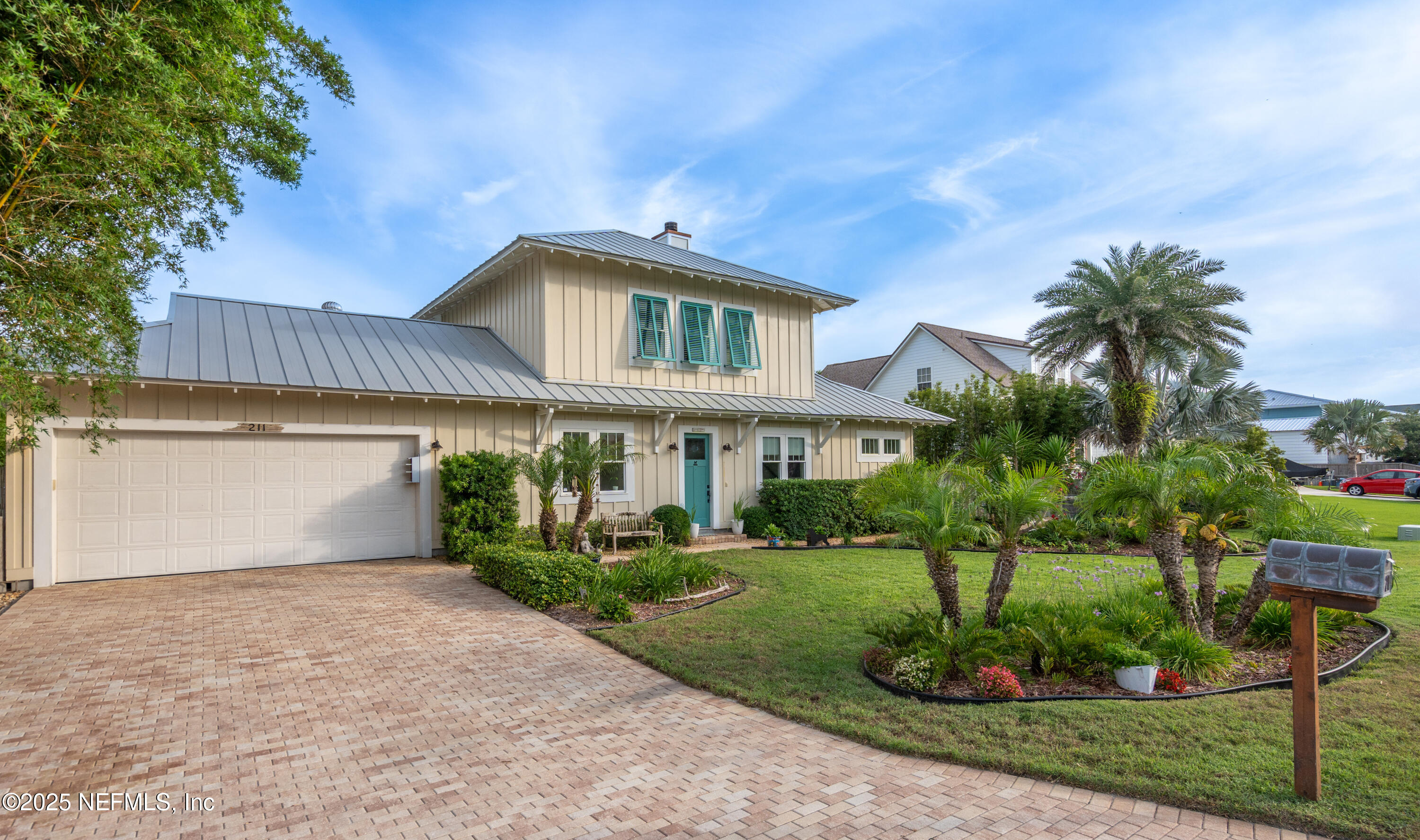 211 10th Street St. Augustine, FL 32080 - Photo 46 of 47 a front view of a house with a yard and garage