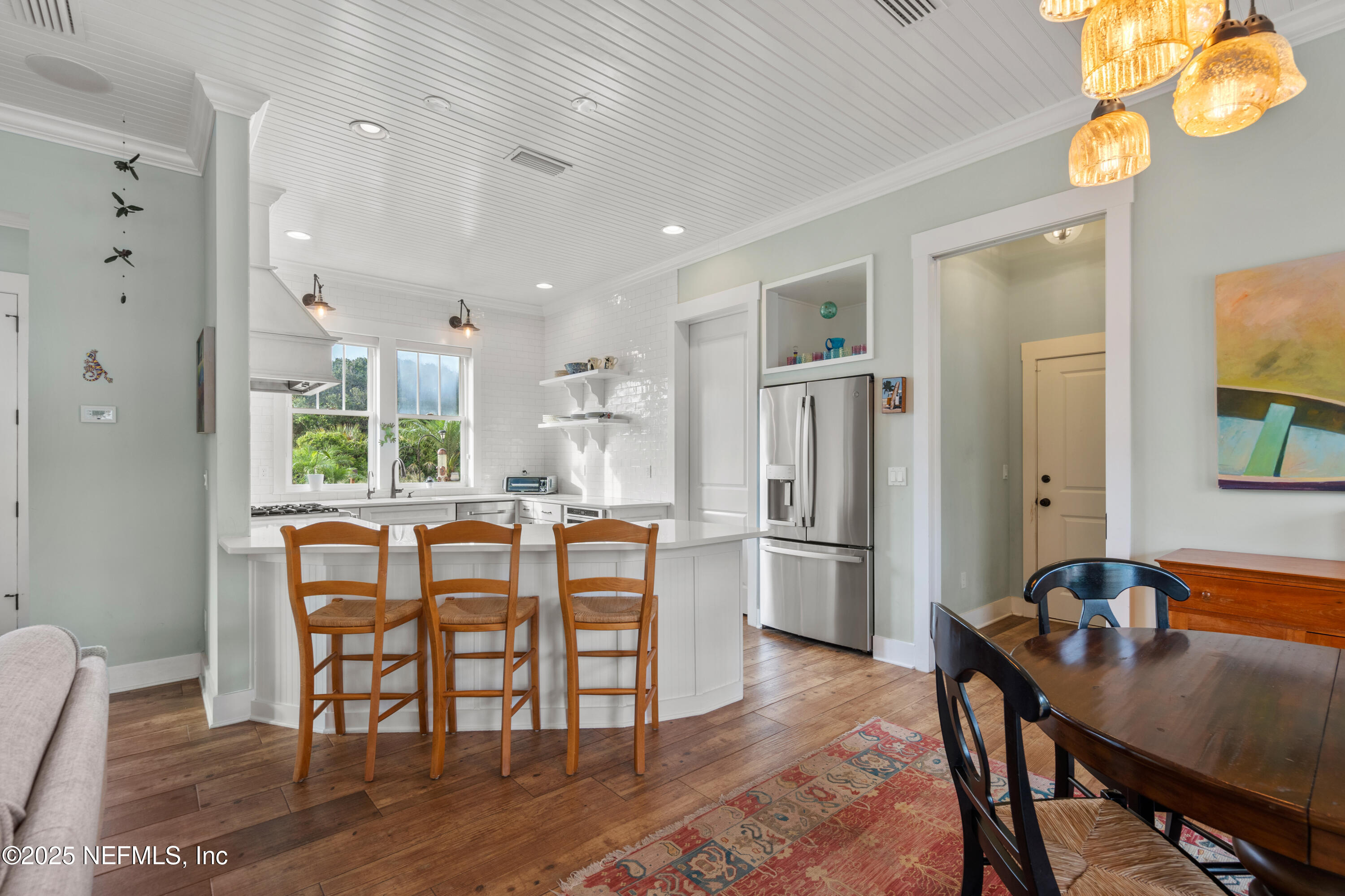 211 10th Street St. Augustine, FL 32080 - Photo 10 of 47 a view of a dining room with furniture window and wooden floor
