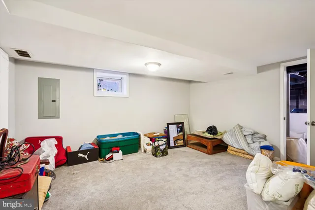 a bedroom with furniture and a lamp