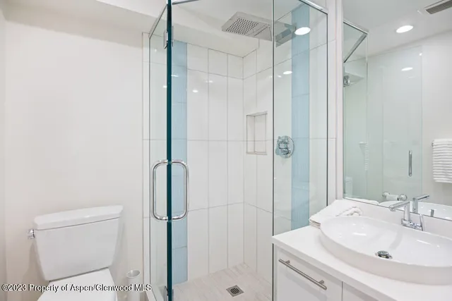a bathroom with a toilet sink and shower