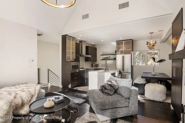 a living room with furniture and kitchen view