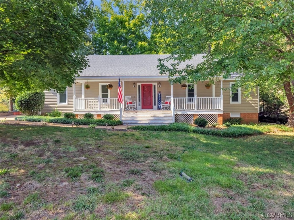 a front view of a house with a yard and green space