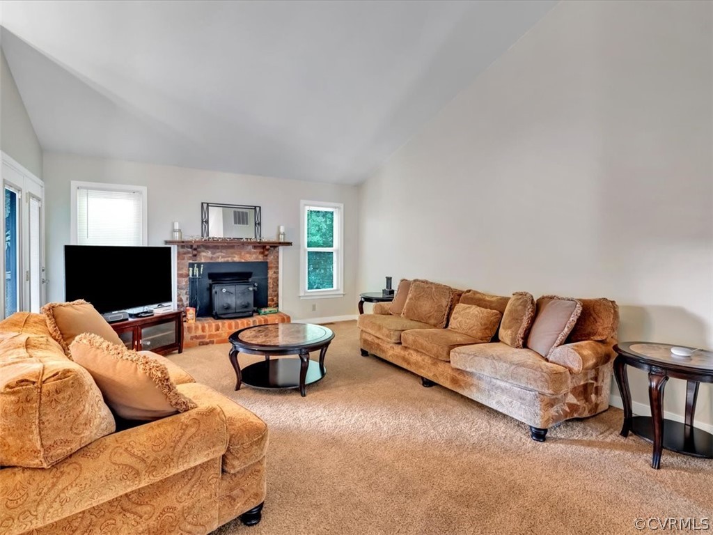7024 Pointer Ridge Road Midlothian, VA 23112 - Photo 4 of 24 a living room with furniture a flat screen tv and a fireplace