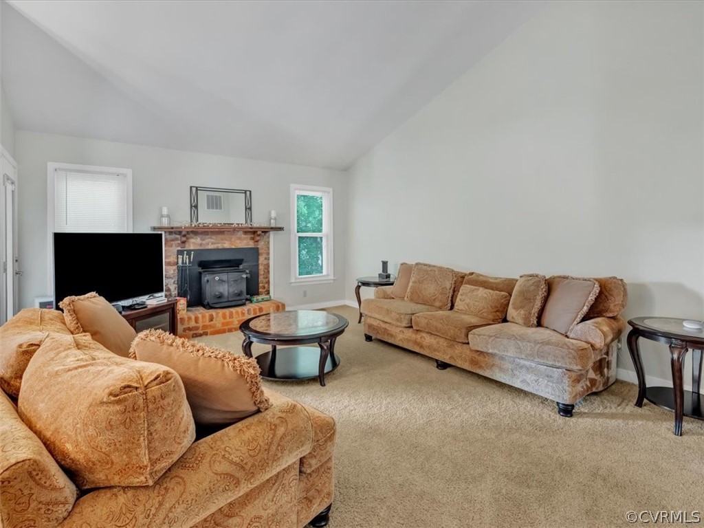 7024 Pointer Ridge Road Midlothian, VA 23112 - Photo 6 of 24 a living room with furniture a fireplace and a flat screen tv