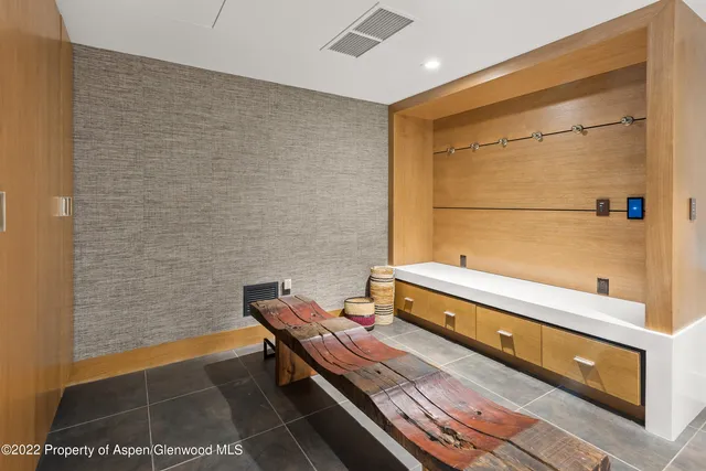 a reading room with wooden floor and furniture