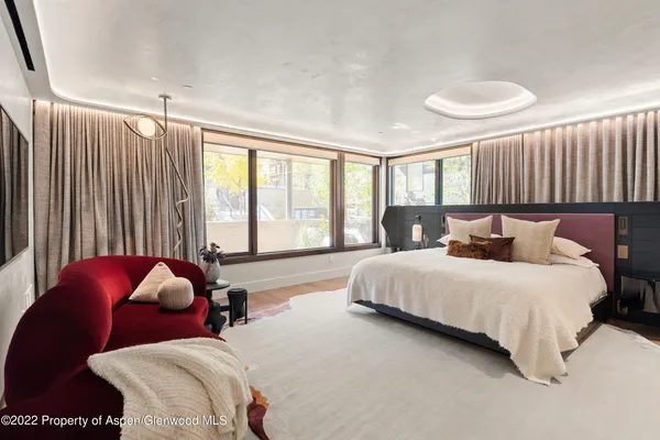 a bedroom with bed and a large window
