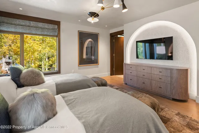 a bedroom with a large bed and a large window