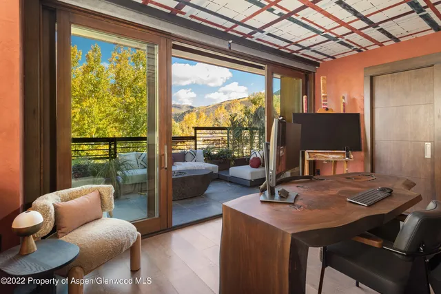 a living room with furniture and a floor to ceiling window