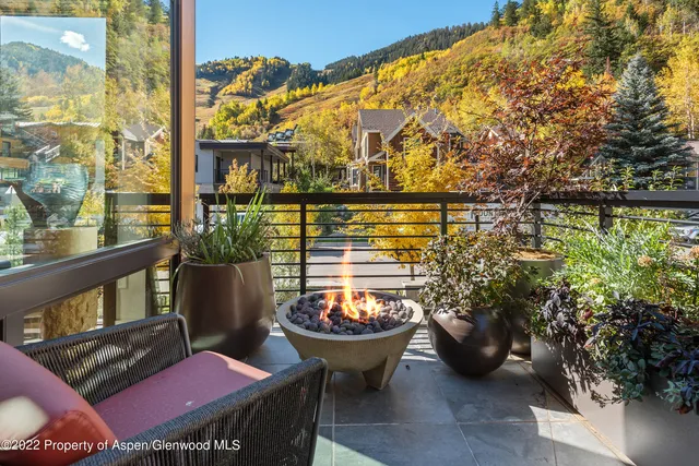 a outdoor living room with furniture and a wooden floor
